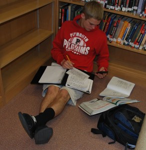 Distracted by his mobile device, Colten Schuler tries to make an effort to complete his homework on time. Photo by: Elizabeth Gallardo