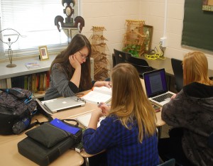 Discussing their ideas on what articles to write, junior Reneh Gambrel helps her group of new journalism students. Photo by: Katie Sommers