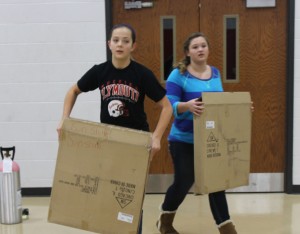 Freshmen Erin Hunter and Riley Rose help set up for the annual Sweetheart dance. 