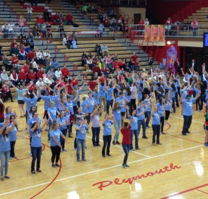 The students that participated in the dance marathon preformed during the half time of the varsity basketball game and were lead by Ball State University dance committee leaders. Photo by: Katie Sommers