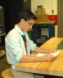 Kennedy Schnieders studies handwritten notes during his Study Hall. The quiet environment of the PLTW room is ideal for a concentrating. Photo by Emory Smith