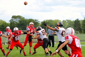 The Plymouth High School varsity football team, 'The Rockies,' play against Warsaw High School's football team. 