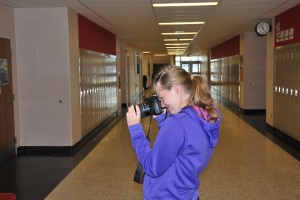 Jordan Kelly takes a photo in the english hallway at Plymouth High School. Photo by: Jon Sommers