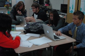 Several yearbook students spend class time working in groups to complete their assignments. Photo by: Chandy Schuler