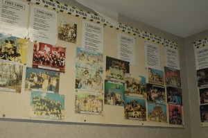 The wall on the staircase to the auditorium is pictures and descriptions for every play that has been put on. Photo By: Taylor Drake