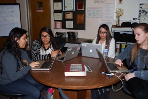 New students Maria, Elia, Stephanie, and Abbigail all working to finish putting pictures up and getting ready to publish their new articles. Photo by: Janessa Salazar