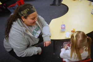 Samantha Grant helping her student pack up everything to take home after the Valentine's party. Photo By: Janessa Salazar