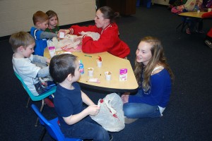 Natalie Wright and Ashley Shepperd help make little Valentine cards to have their students take home to their parents. Photo By: Janessa Salazar