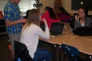 Working with editor Eric Burch, Megan and Sydney continue putting responses into their articles. Photo by: Janessa Salazar