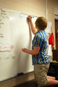 Eric Burch updating the whit board. Photo by, Janessa Salazar