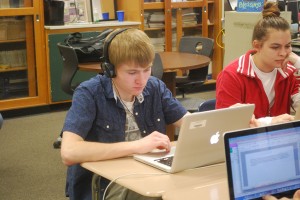 Cam Mullins works diligently in Journalism class to meet a deadline. Photo by Janessa